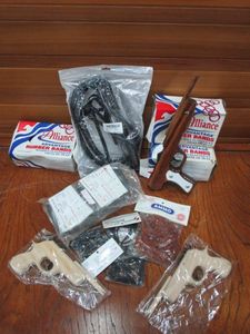 lot 175 image: FULLY CUSTOMIZED RUBBER BAND GUN, 2 ADDITIONAL PISTOL STYLE RUBBER BAND GUNS, VERY GENEROUS QUANTITY OF RUBBER BAND AMMO, A LARGE WHIP STILL IN PACKAGING