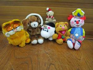 lot 180 image: VINTAGE 1984 FISHER PRICE PLUSH TEACH ME TO DRESS CLOWN, 1987 MUPPETS BABY FOZZIE BEAR, 1981 PLUSH GARFIELD, 12 VINTAGE EARLY 80s AVON BROWN PUPPY WEARING JACKET, VNTG SMALL XMAS BEAR, VNTG PLUSH COW