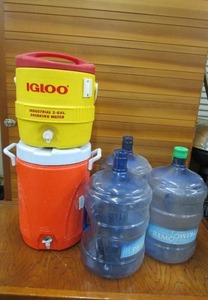 lot 214 image: IGLOO 3 GAL WATER COOLER, RUBBERMAID 5 GAL WATER COOLER, (3) 5 GAL EMPTY WATER JUGS, 2 HAVE NO CAPS