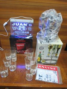 lot 220 image: HOME BAR LOT, 6 BOTTLE CAPACITY ROTATING SHOOTER, DRINKO PARTY GAME W SHOT GLASSES, VNTG BUDWEISER TABLE CLOTH NEW, DRINKING GLASSES, HANGING LIGHT UP SIGN JUANS HOMEBAR