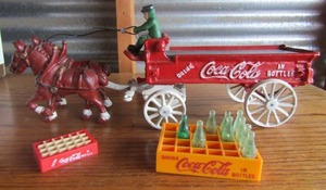 lot 113 image: Coca Cola wagon 2 horses , driver  all heavy metal, Mini coke crate empty, coke bottle crate mini with 9 bottles,
