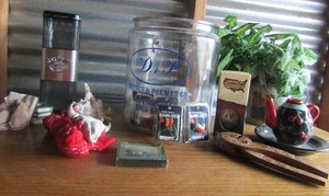 lot 125 image: Jack Daniel tin box, Squirrel  book dcor,  Dryden & Palmer Old Fashion Rock Candy glass decantor, Mini cow head  Flashing jewlery Texas flag pin   wooden nut cracker