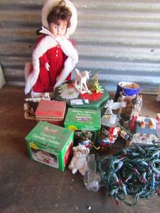 lot 143 image: Christmas lot- candle holder x3 angel  ornament, tins, lights and villages