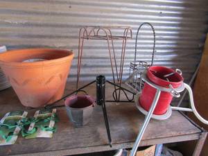 lot 176 image: Metal christmas tree stand, plant stand , assorted planter pots, 3 new frog plant ties
