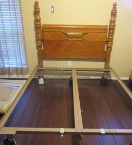 lot 12 image: Hollywood Regency 1940s Full size headboard and foot board with metal frame and bed lift risers. Frame on wheels