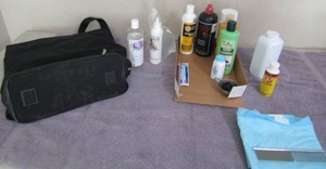 lot 98 image: Used dog shampoo, puppy pad, metal comb, travel bag