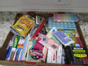 lot 127 image: Flat box of misc. bath items like medicine boxes, Razors, new toothbrushes sports cream hair ties etc.