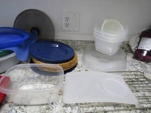lot 144 image: Tupperware bowls  Rubbermaid bakeware  Plastic plates  wicker plate holders