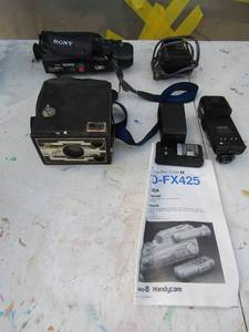 lot 291 image: Sony video camera recorder 8- charger and batteries Vintage camera lens box