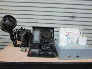 lot 29 image: CASH DRAWER, RETAIL RECEIPT PAPER ROLLS, QTRAIN CASSETTE TRAINING BOX W EARPHONES, LARGE VINTAGE BLAK-RAY BLACKLIGHT, QTRAIN & BLAK-RAY BOTH POWER ON