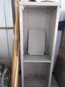lot 12 image: Large bundle of wood framing pieces, gray outdoor storage shed no front doors 69x26x16