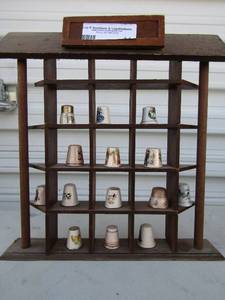lot 41 image: Brown thimble shelf   13 thimbles