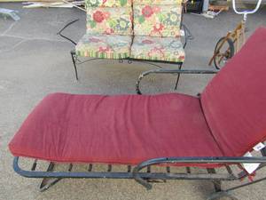 lot 76 image: Metal outside 2 seater bench with floral cushions 28x54x29    red folding metal lounger with red cushions
