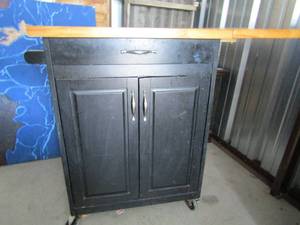lot 128 image: Rolling portable islandbar with fold out side table, double door 1 drawer at the top    front wheel needs to be reattached