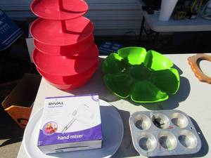lot 315 image: Green Tupperware divided tray, 5 tier red server, NIB rival hand mixer, 6 muffin pan