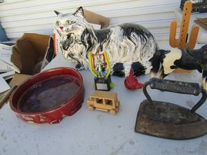 lot 354 image: Ceramic cat, toy horse, cast iron water bowl swinging bugs bunny