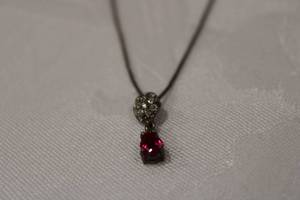lot 362 image: Sterling silver 18L box chain ( marked 925 Italy) with an articulated tear shaped Ruby pendant (Ruby tested). Also marked 925
