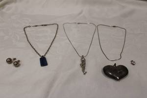 lot 363 image: Sterling silver (unmarked) grouping. Includes 16L chain with caged pearl mermaid pendant, 16L chain with Blue Quartz slab pendant 14L snake chain, Puffed heart pendant, ball post earrings and a heart pendant