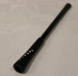 lot 381 image: 1940s era (Probably Bakelite) spring loaded cigarette holder. Once cigarette is finished push the handle in and the spring loaded mechanism ejects the cigarette butt