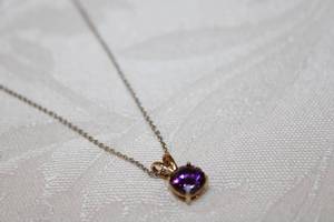 lot 421 image: Sterling Silver 18L chain with sterling gold plated vermeil Amethyst pendant. Amethyst tested. Marked 925 on both chain and pendant.