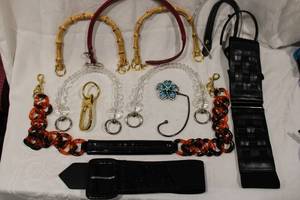 lot 439 image: Selection of decorative leather and non leather purse handles including acrylic, bamboo etc.. Includes an ell skin belt, flower form table purse holder plus