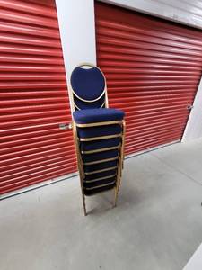 lot 343 image: Stackable Blue Fabric Chairs with Gold Frame and Circle Back - 10 Total (Sunday Pickup only 2-5p preview by appointment only.)