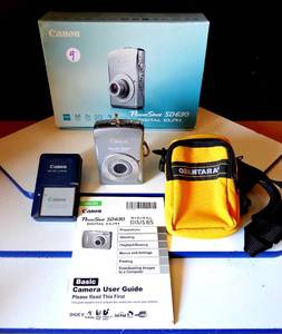 lot 9 image: Canon PowerShot SD630 Digital ELPH 6.0 MP Camera SILVER wManual and Accessories $$