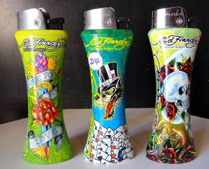 lot 214 image: ED HARDY JUMBO CURVE Refillable LIGHTERS - COLLECTION OF 3 - WITH BOTTLE OPENER (X3)