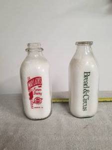 lot 11 image: Maylaths Dairy and Bread & Circus glass milk bottles