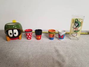 lot 24 image: Set of 4 Disney shot glasses and a Marvin the Martin glass and coffee mug