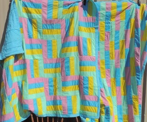 lot 116 image: 2 handmade matching quilts pink, yellow and blue