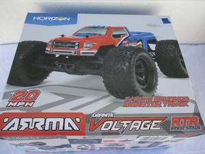 lot 7 image: ARRMA RC Monster Truck 110 Granite Voltage MEGA,2WD, SRS, RTR with 2.4GHz Radio,1800mAh 6C NiMH Battery Charger, (RedBlack)