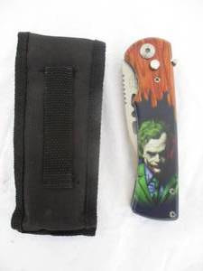 lot 40 image: NEW-Automatic  Switch Blade Knife And Sheath-Wood looking Handle And THE  JOKER