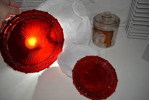 lot 120 image: Red Glass Plates - 7 Dinner Plates, 2 Dessert Plates and Jar marked 5th District
