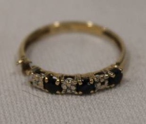 lot 434 image: 10K yellow gold and Sapphire ring, Marked 10K Shank damaged. Contains (3) .48 carat blue sapphires. Sapphires tested.