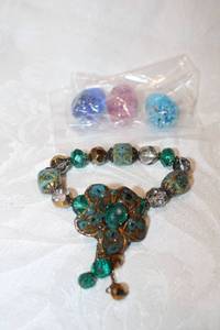 lot 431 image: Glass and blue faience ceramic bead stretch bracelet with ceramic artisan crafted flower frontis piece. Also includes (3) glass speckled eggs. Approx. 1.25H each
