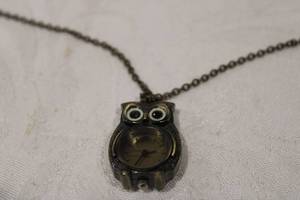 lot 428 image: Claires pendant watch in owl form on 30 bronze finish chain. Exaggerated eyes on owl.