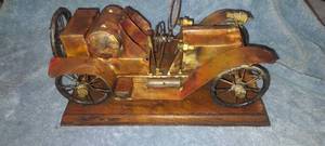 lot 21 image: Model of antique car made out of brass mounted on wood base