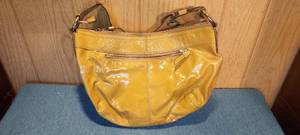 lot 74 image: Tan leather Coach bag.....has staining