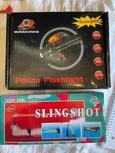 lot 4 image: Police Flashlight- rechargeable by K&S and Hawk slingshot by  K&S