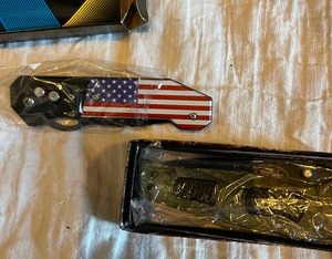 lot 195 image: 2 pocket knifes- USA flag with clip 3 blade and camo 3.5blade