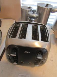 lot 130 image: Oster toaster and  flour and sugar covered cannisters