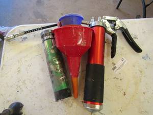 lot 47 image: Grease gun, funnels and tub o grease