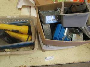 lot 51 image: Box of home outlet plugs covers and Flashlights