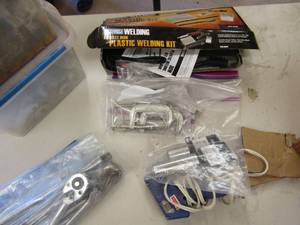 lot 202 image: Clamps in 2 tubs, plastic welding kit, bag of clamps hot glue gun