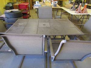 lot 209 image: Outdoor tile top patio set with 5 chairs that rock. 28x64x40 great condition
