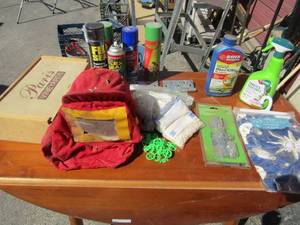 lot 233 image: Assorted tile spacers, many cans of flex seal, fire helmet with face shield and veggie spray