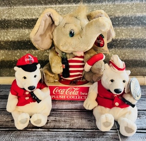 lot 166 image: Three Exclusive & Us Coca-Cola Plush Polar Bears and Elephant