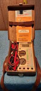 lot 16 image: Vintage Simpson Ohm Meter with original instruction book and leather case