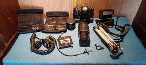 lot 71 image: Vintage photography equipment.  35 mm camera, flash, zoom lens, filters, tripod, etc